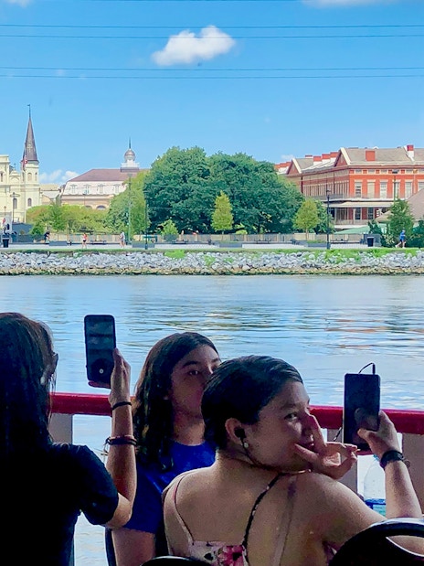 People photographing the view of St. Louis Cathedral from Steamboat Natchez in New Orleans.