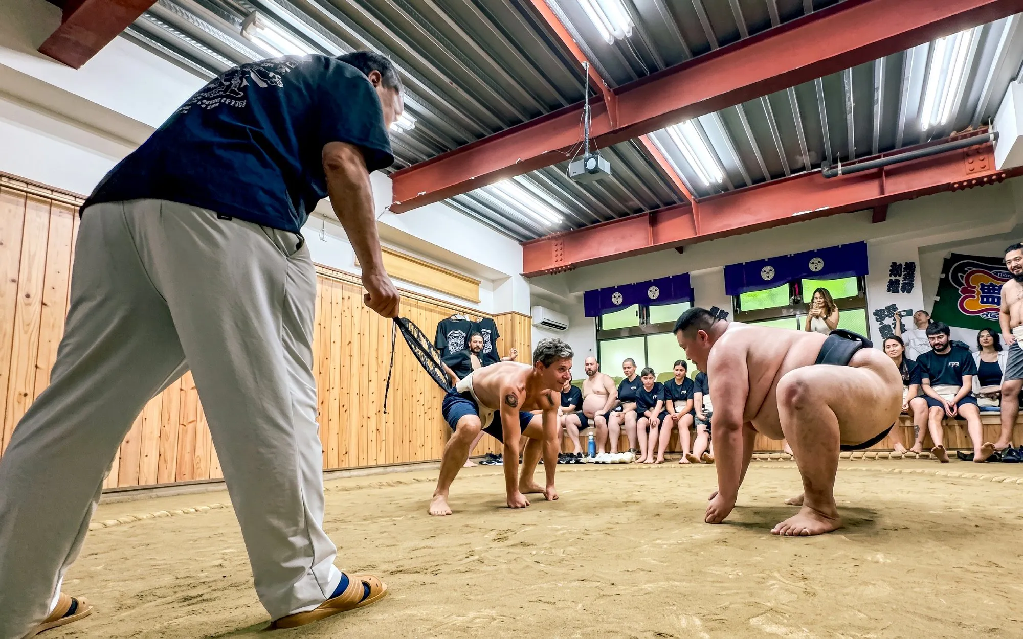 Sumo wrestlers preparing to engage in a match during an authentic experience in Tokyo.