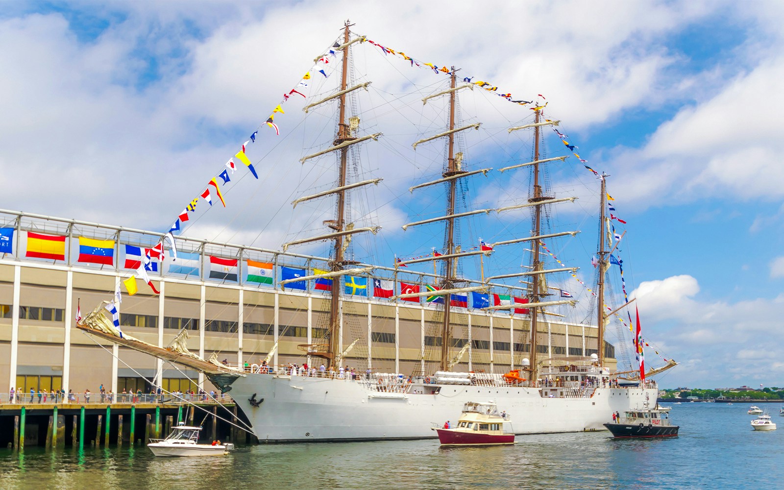 Peruvian tall ship sailing near rocky coastline in Lima, Peru.
