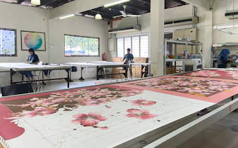 Batik painting demonstration at Royal Selangor Pewter factory with artists at work.