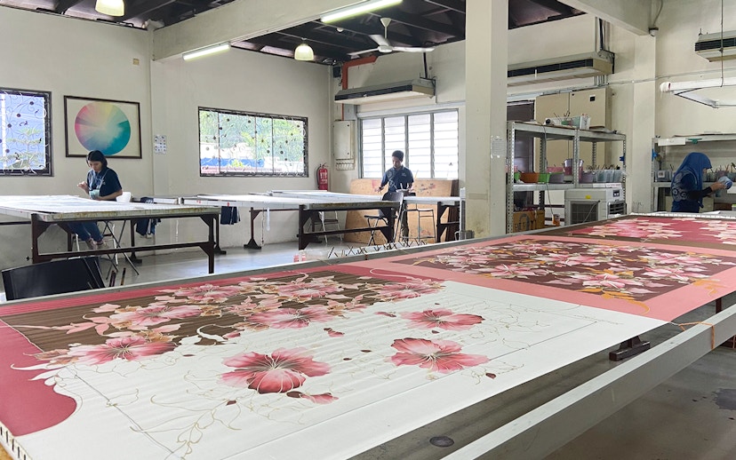 Batik painting demonstration at Royal Selangor Pewter factory with artists at work.