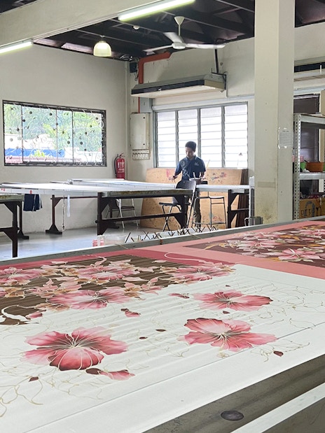 Batik painting demonstration at Royal Selangor Pewter factory with artists at work.