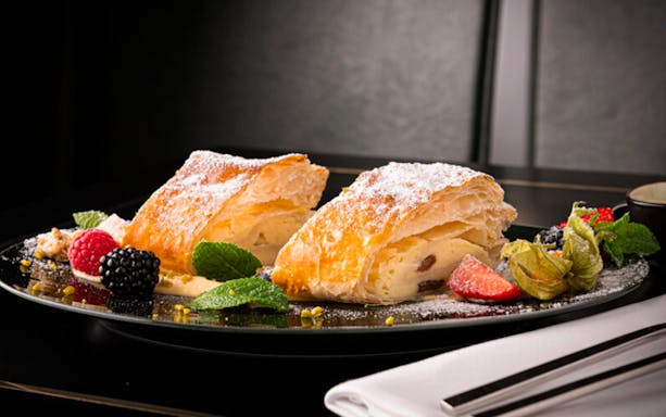Pastry with fruit garnish at Café Wintergarten breakfast.