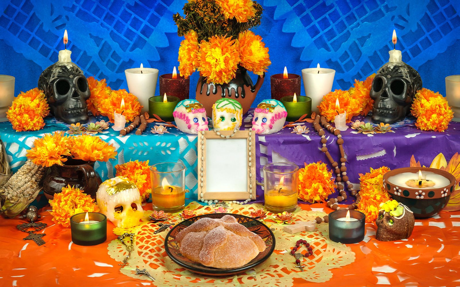 Mexican Day of the Dead altar with sugar skulls, marigolds, and bread of the dead.