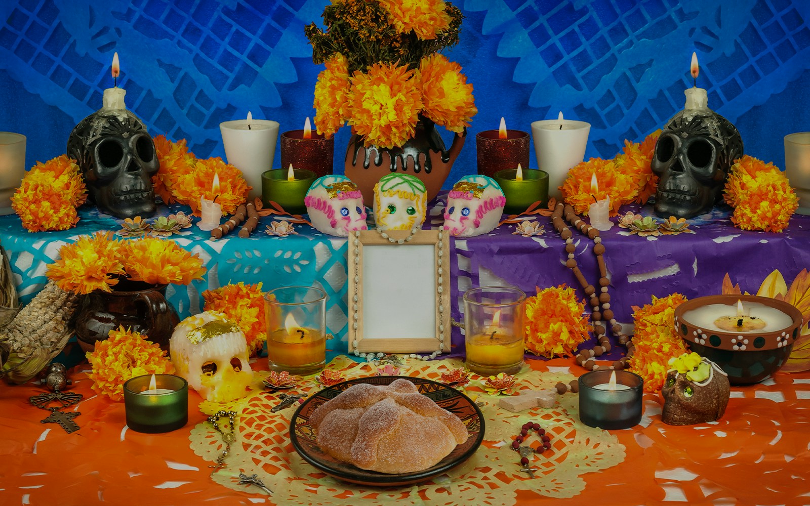 Mexican Day of the Dead altar with sugar skulls, marigolds, and bread of the dead.