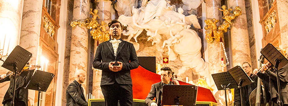 Karlskirche concert with musicians performing Vivaldi’s Four Seasons in ornate baroque interior.