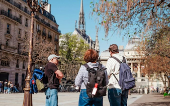Tourists on Île de la Cité with Notre-Dame Cathedral in the background.