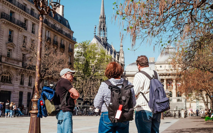 Tourists on Île de la Cité with Notre-Dame Cathedral in the background.