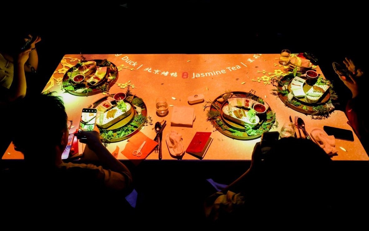 Dining table with Peking duck and jasmine tea at Taste of China, Shanghai.