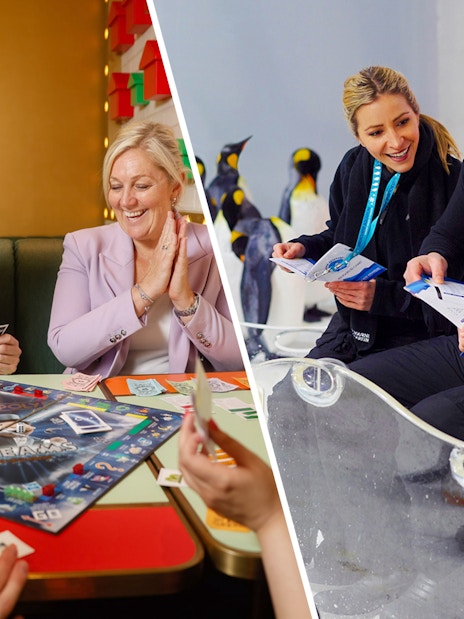 Visitors enjoying Penguin Passport experience at SEA LIFE Melbourne with penguins in the background.