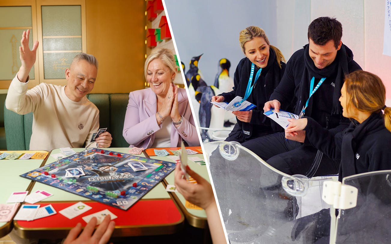 Visitors enjoying Penguin Passport experience at SEA LIFE Melbourne with penguins in the background.