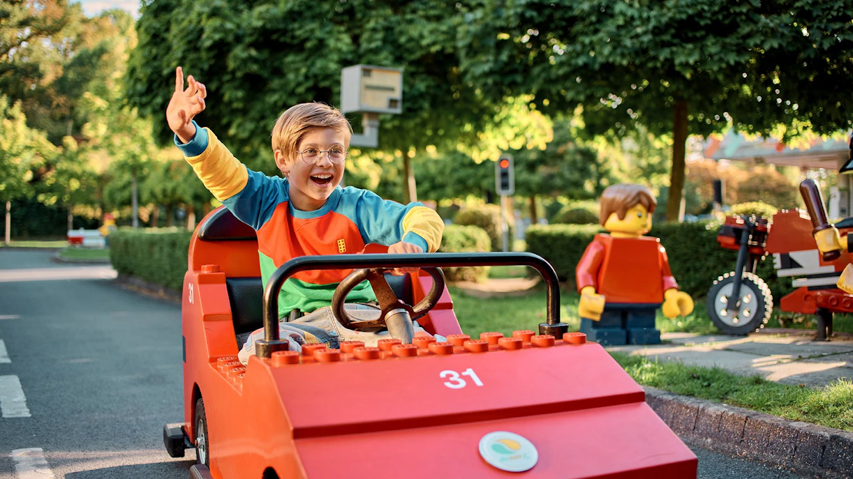 Child driving a LEGO car at LEGO City Driving School, LEGOLAND Windsor Resort.