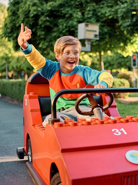 Child driving a LEGO car at LEGO City Driving School, LEGOLAND Windsor Resort.