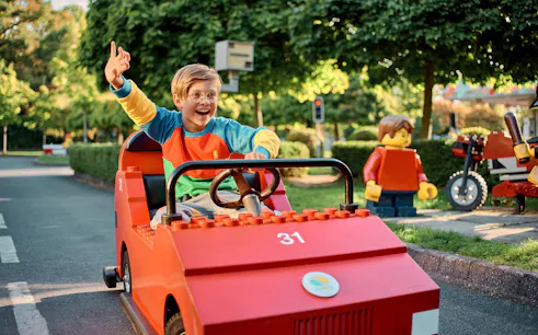 Child driving a LEGO car at LEGO City Driving School, LEGOLAND Windsor Resort.