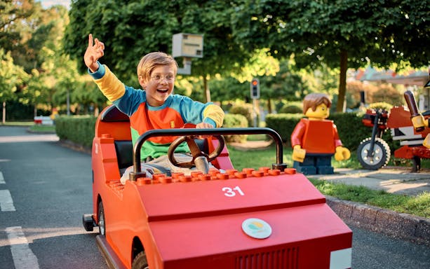 Child driving a LEGO car at LEGO City Driving School, LEGOLAND Windsor Resort.