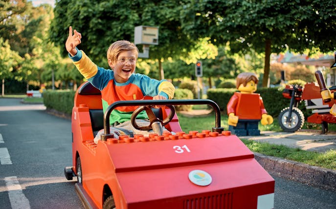 Child driving a LEGO car at LEGO City Driving School, LEGOLAND Windsor Resort.