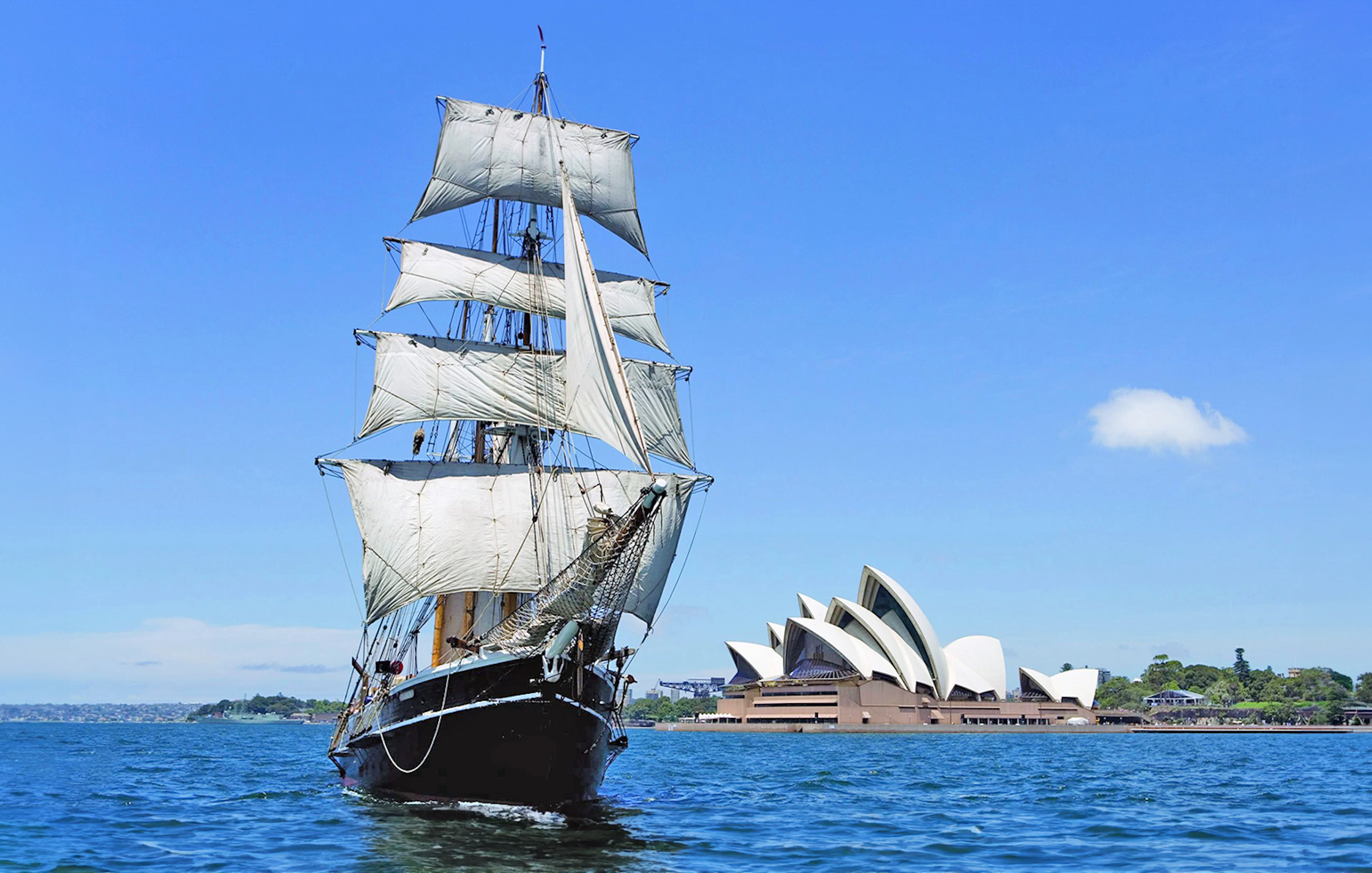 Tall ship sailing in Sydney Harbour with Sydney Opera House in the background.
