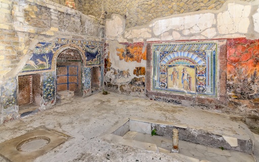 Ancient frescoes and mosaics in a room at Herculaneum, part of the Pompeii & Herculaneum guided tour.