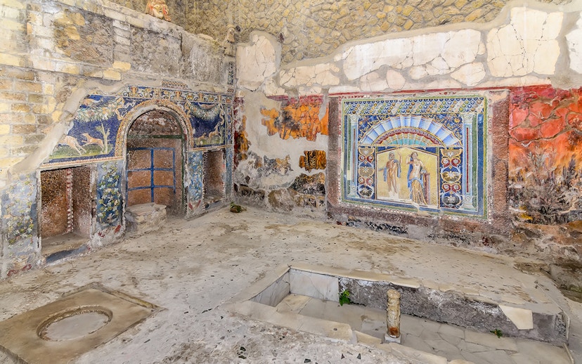 Ancient frescoes and mosaics in a room at Herculaneum, part of the Pompeii & Herculaneum guided tour.