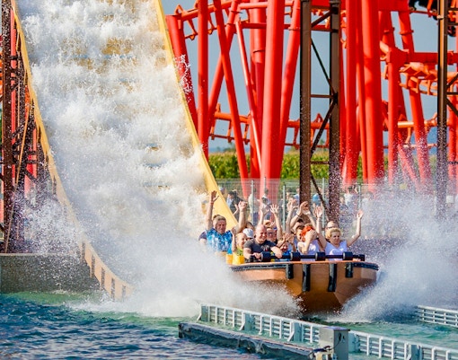 Roller coaster Anaconda at Energylandia theme park, Poland, with vibrant loops and twists.