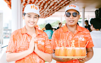 Crew members on Pattaya luxury yacht serving drinks during 3-island cruise.