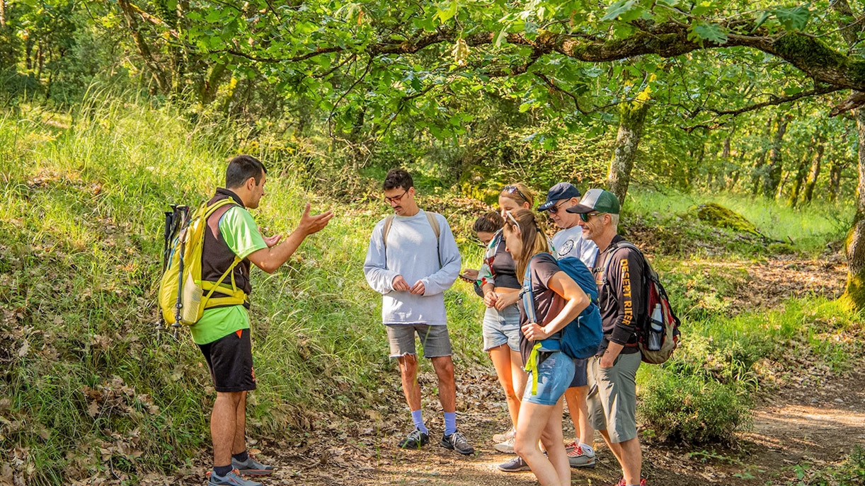 Guests hiking on a trail with Meteora rock formations in the background during a Meteora Hiking Tour with Monastery Visit.