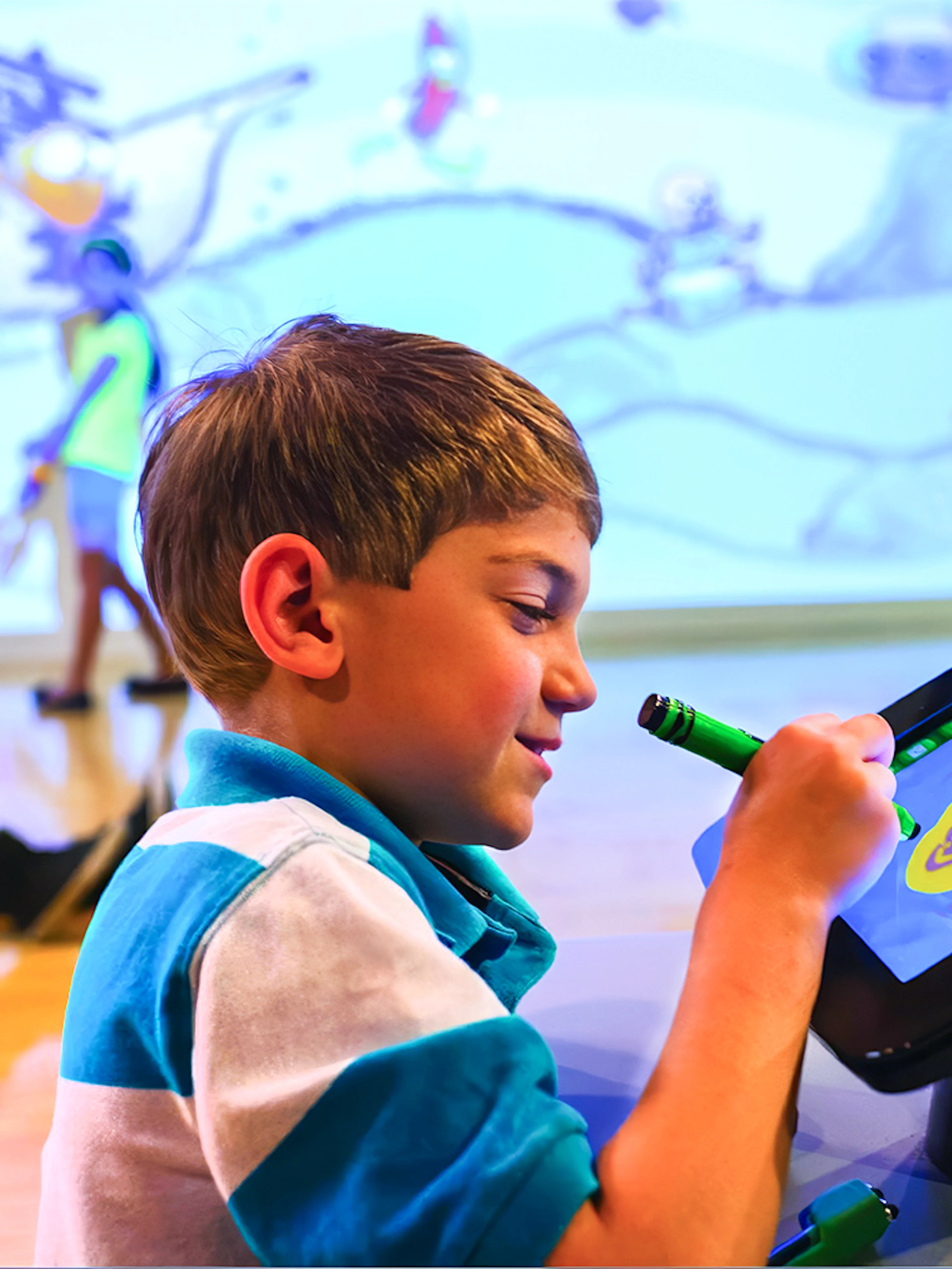 Child drawing on digital screen at Crayola Experience in Orlando.