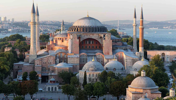 Hagia Sophia in Istanbul with minarets and Bosphorus view in the background.