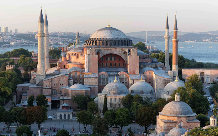 Hagia Sophia in Istanbul with minarets and Bosphorus view in the background.