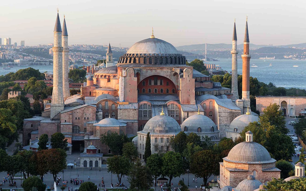 Hagia Sophia in Istanbul with minarets and Bosphorus view in the background.
