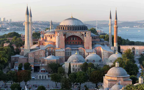 Hagia Sophia in Istanbul with minarets and Bosphorus view in the background.