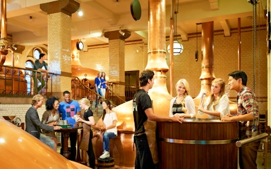 Visitors enjoying a tour inside the Heineken brewery, Amsterdam.
