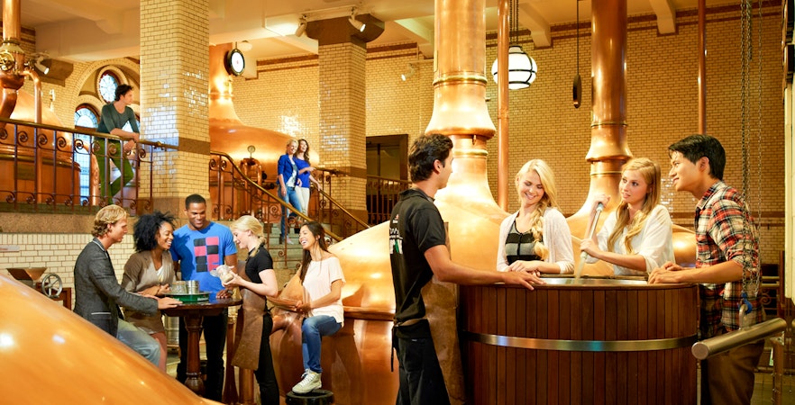 Visitors enjoying a tour inside the Heineken brewery, Amsterdam.