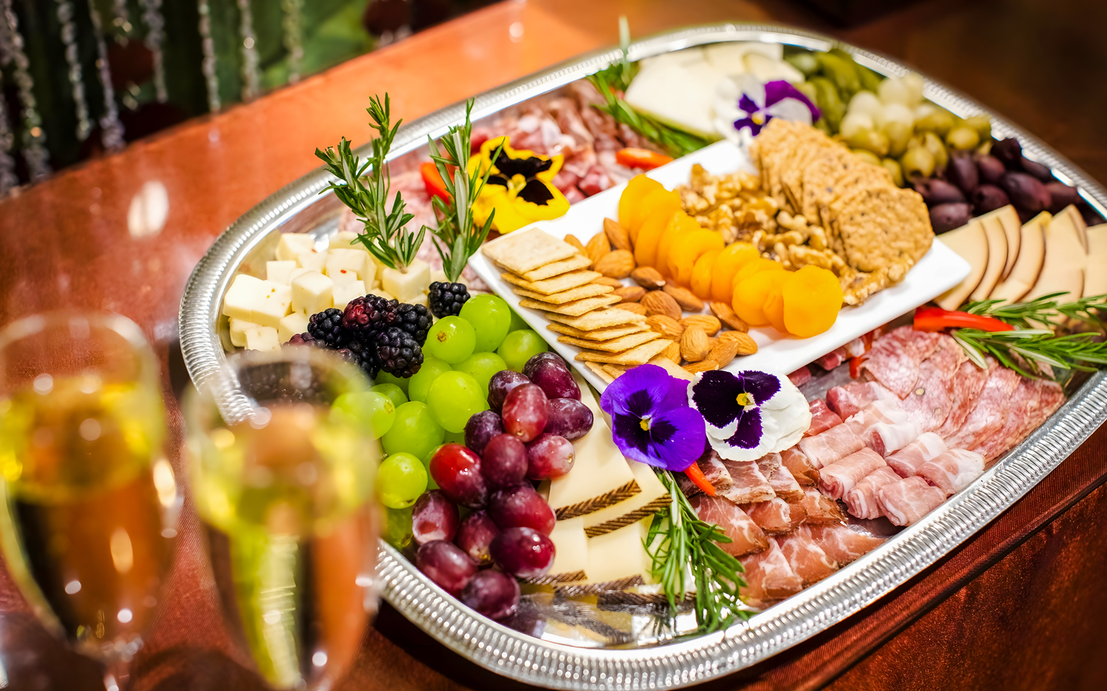 Cheese and charcuterie board with fruits and nuts at Waikiki Luau, Honolulu.