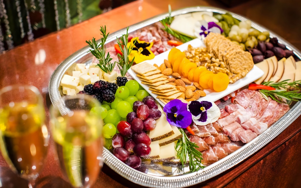 Cheese and charcuterie board with fruits and nuts at Waikiki Luau, Honolulu.