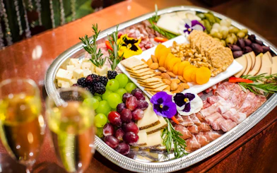 Cheese and charcuterie board with fruits and nuts at Waikiki Luau, Honolulu.