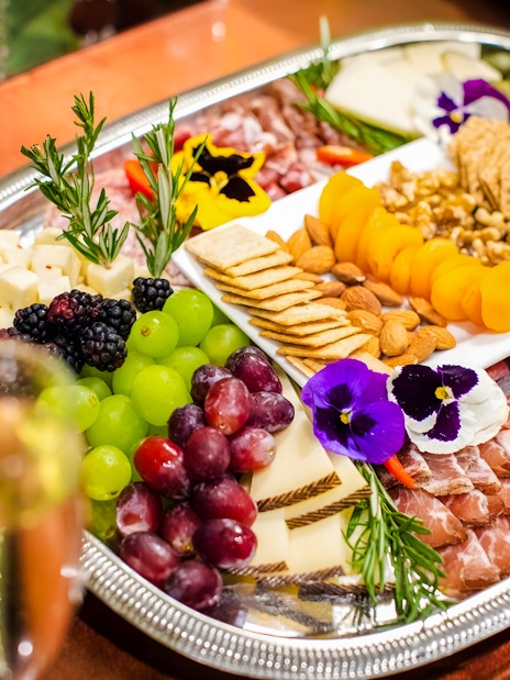 Cheese and charcuterie board with fruits and nuts at Waikiki Luau, Honolulu.
