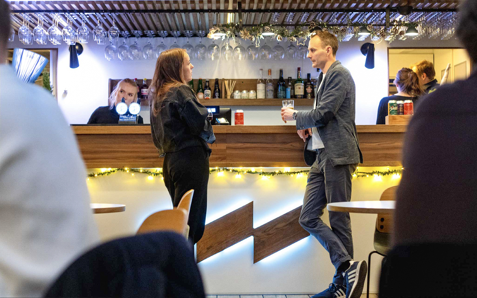 Bar area on Oslo dinner cruise with people enjoying drinks.