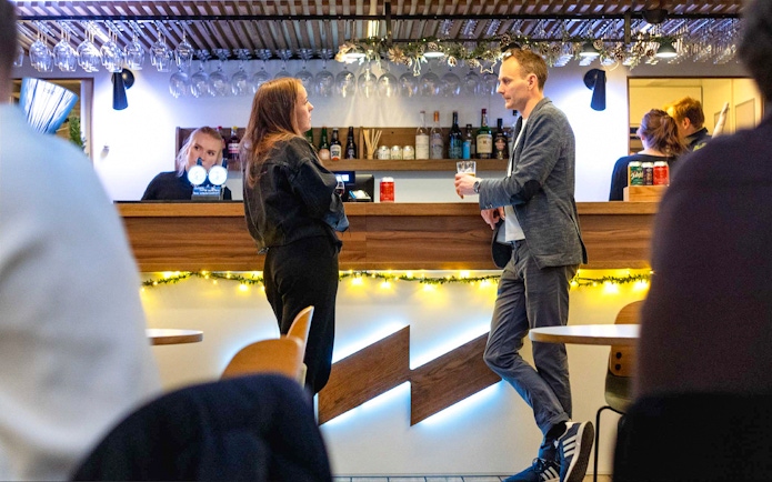 Bar area on Oslo dinner cruise with people enjoying drinks.