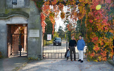 Entrance to Fryderyk Chopin's birthplace in Poland with autumn foliage.