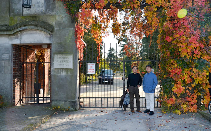 Entrance to Fryderyk Chopin's birthplace in Poland with autumn foliage.