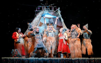 Performers in elaborate costumes on stage during Cirque du Soleil KÀ show.