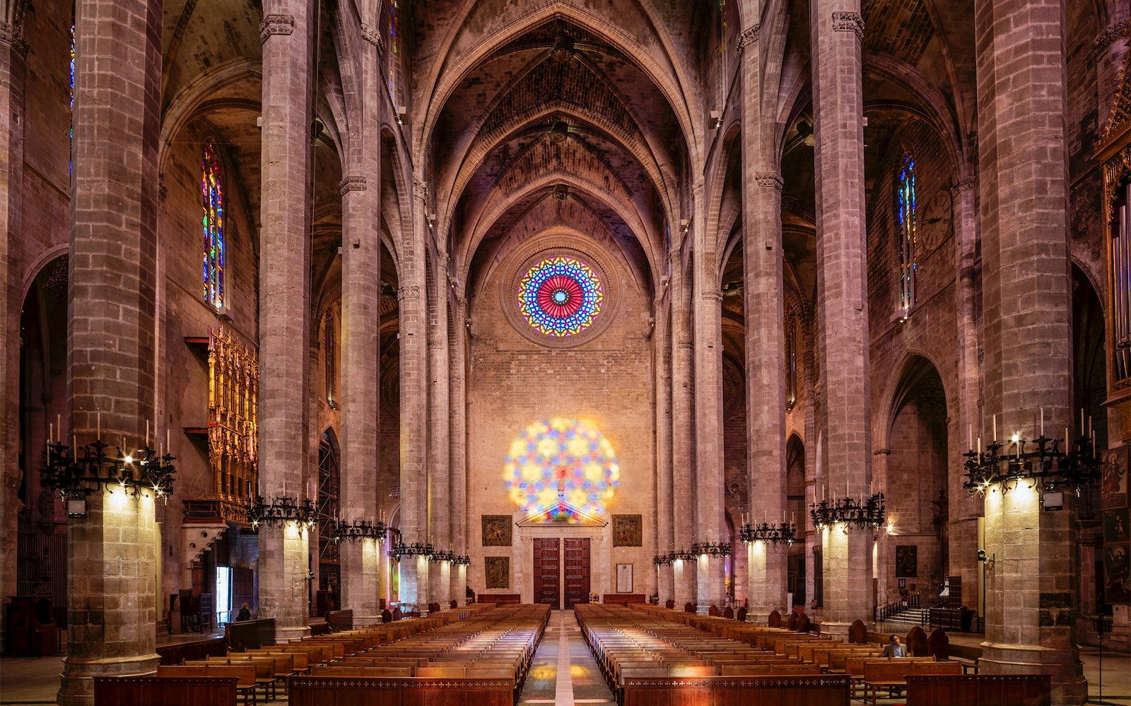 Lit up 8-figure pattern of the rose window inside Palma Cathedral