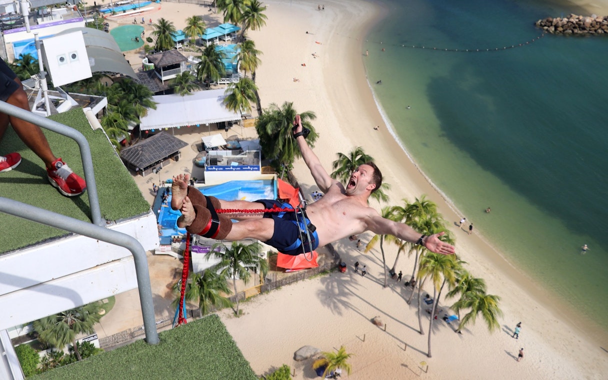 Bungee jumper over beach at Skypark Sentosa by AJ Hackett, Singapore.