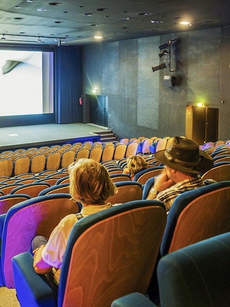Cinema seating at Pont du Gard museum, showcasing a film experience.
