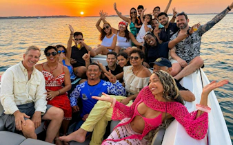 Group enjoying a sunset party cruise on a boat in Cartagena.