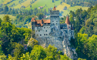Bran Castle surrounded by lush greenery, near Bucharest, Romania.