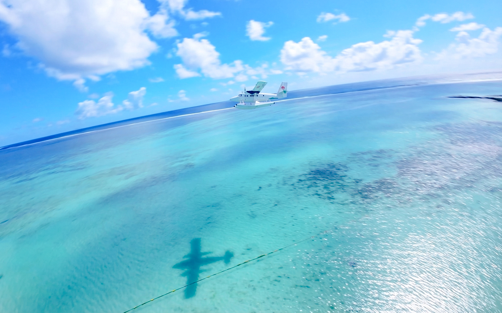 Seaplane flying over turquoise waters in Mauritius during scenic tour.