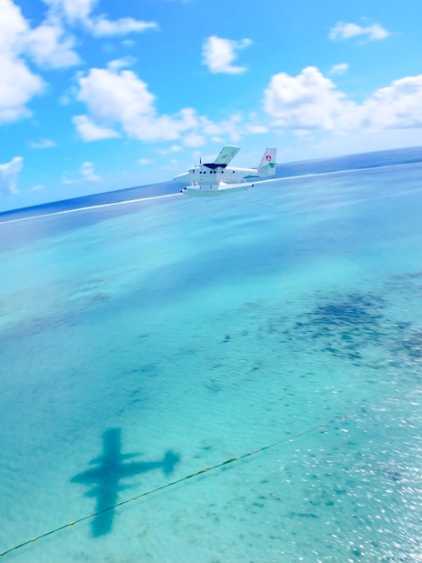Seaplane flying over turquoise waters in Mauritius during scenic tour.