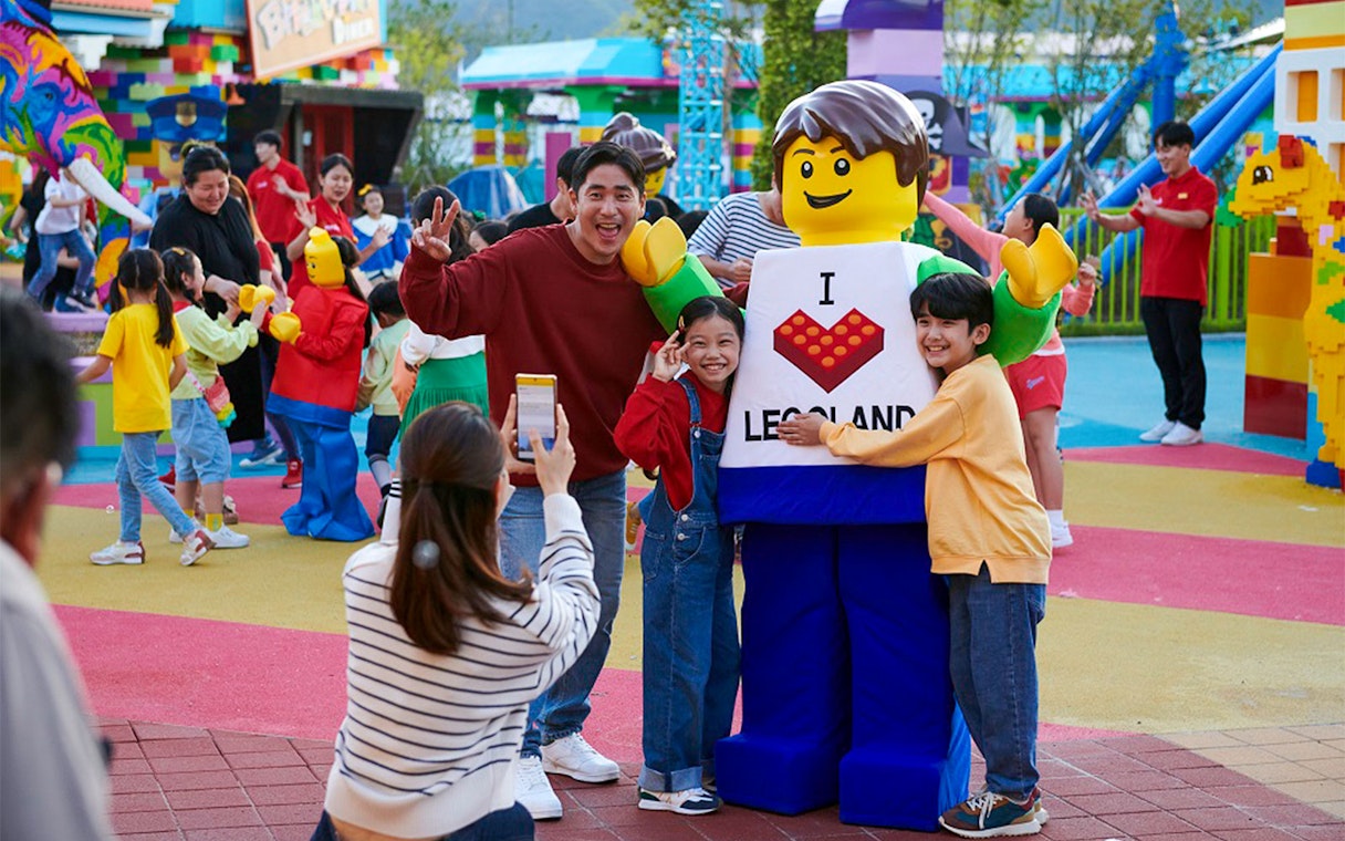 Visitors posing with LEGO character at LEGOLAND Korea.